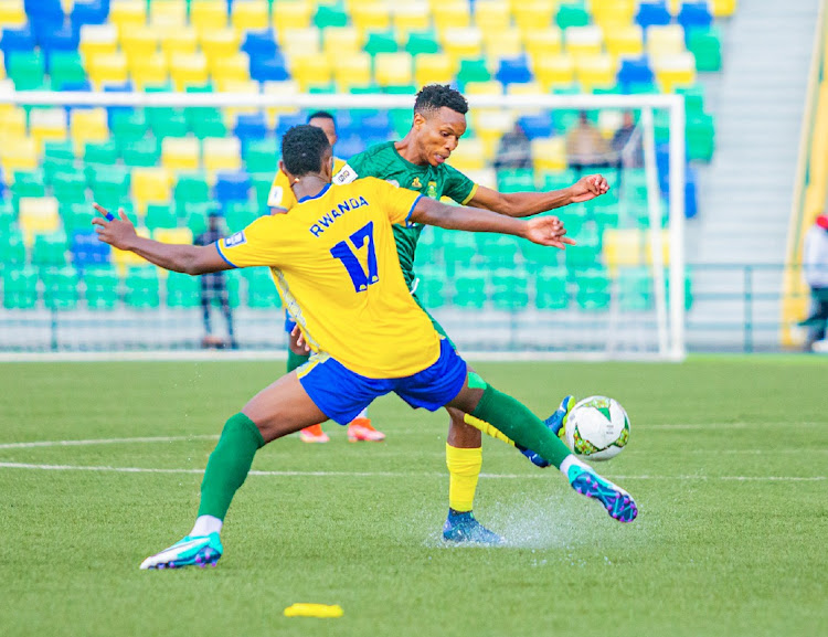 Themba Zwane of South Africa challenged by Thierry Manzi of Rwanda during the 2026 FIFA World Cup Qualifiers between Rwanda and South Africa at Huye Stadium in Butare, Rwanda. Picture: JULIUS NTARE