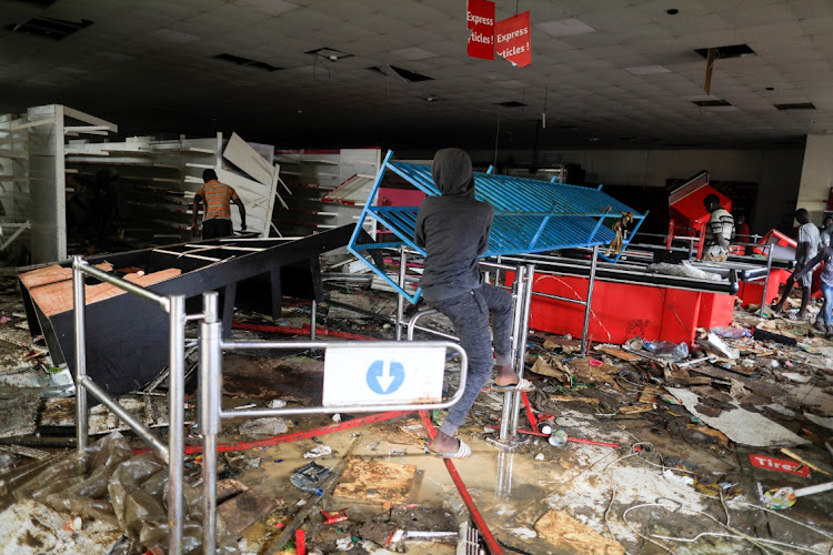 A boy is pictured inside a ransacked supermarket Auchan, after opposition leader Ousmane Sonko was arrested following sexual assault accusations, in Dakar, Senegal March 5, 2021.