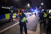 A police officer walks during a protest against the lockdown, amid the spread of the coronavirus disease (Covid-19), in London, Britain March 20, 2021. 