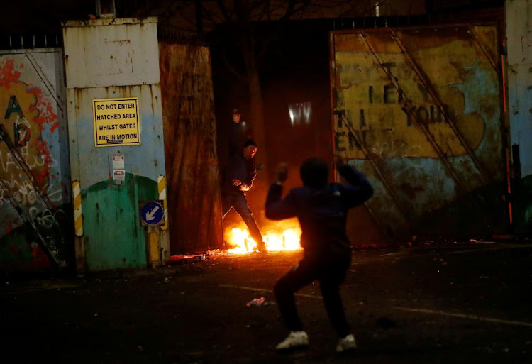 Protesters are seen at the "peace wall" gate into Lanark Way as protests continue in Belfast, Northern Ireland, on April 7 2021.