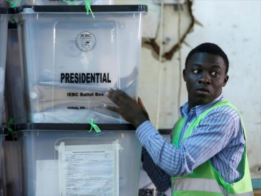 An Independent Electoral and Boundaries Commission official stacks ballot boxes at a tally centre in Nairobi, October 27, 2017. /REUTERS