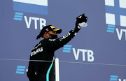 Third placed Lewis Hamilton of Great Britain and Mercedes GP celebrates on the podium during the F1 Grand Prix of Russia at Sochi Autodrom on September 27 2020.