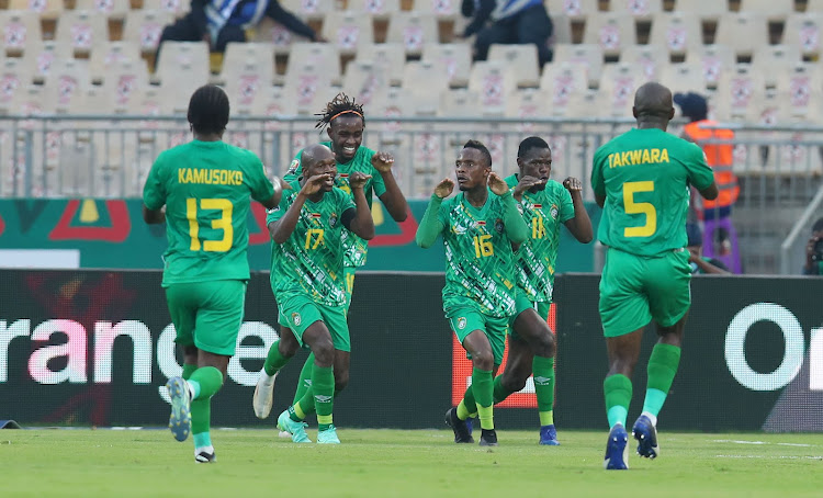 Zimbabwe captain Knowledge Musona celebrates with teammates after scoring the opening goal.