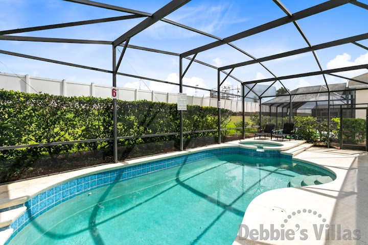 Sunny secluded pool and spa deck at this Windsor Palms vacation villa