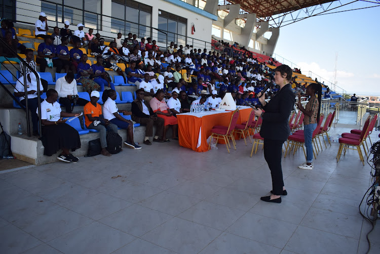 Megan Mukuria speaks to residents during the launch of hotline and whatsApp numbers to help in curbing GBV and teen pregnancies on November 27,2023