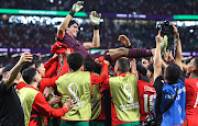 Morocco goalkeeper Yassine Bounou is thrown in the air as Morocco celebrate their victory during the Fifa World Cup Qatar 2022 round of 16 match between Morocco and Spain at Education City Stadium on December 6 2022 in Al Rayyan, Qatar. 