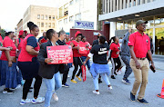 Workers affiliated to the National Education Health and Allied Workers' Union picket outside the Sars offices in Gqeberha. File image.