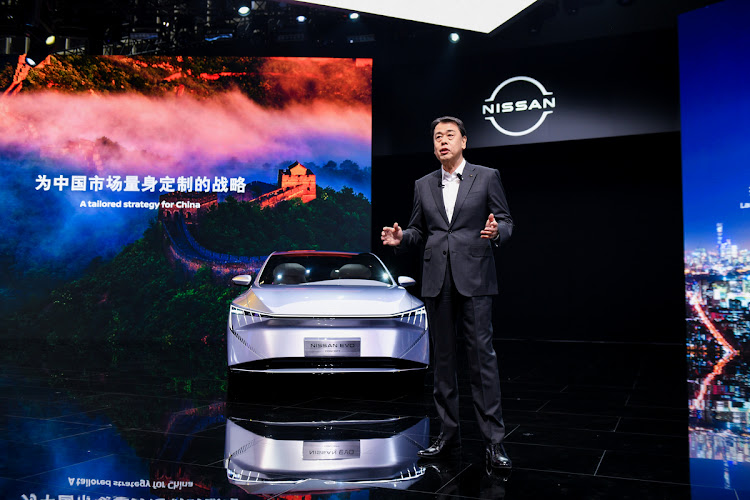 Nissan CEO Makoto Uchida's interest was piqued when he visited a Huawei booth and listened to representatives explain the systems developed for the Seres car on display.