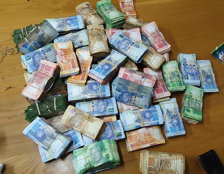 Police seized R700,000 in cash from the home of on alleged drug dealer.