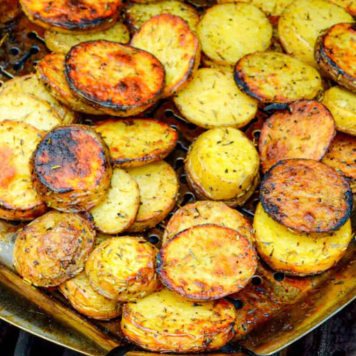 Easy and tasty Grilled Potatoes with herbs are cooked in a grill basket or aluminum foil right on top of your charcoal or gas grill.  They are the perfect side for all your summer grilling and barbecue recipes.
