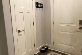 Apartment door entrance and closet with dog bowl and coat hooks