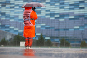 A track marshal shelters under an umbrella at the rain-sodden Sochi Autodrom on September 25, 2021 in Sochi, Russia.