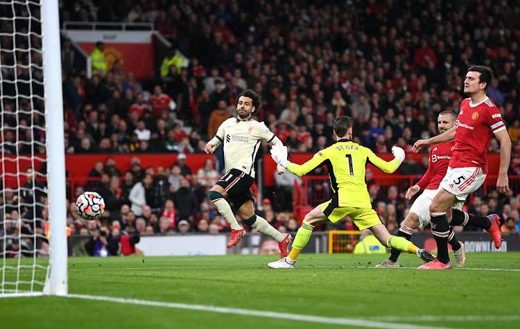 Mohamed Salah scores one of his three goals at Old Trafford.