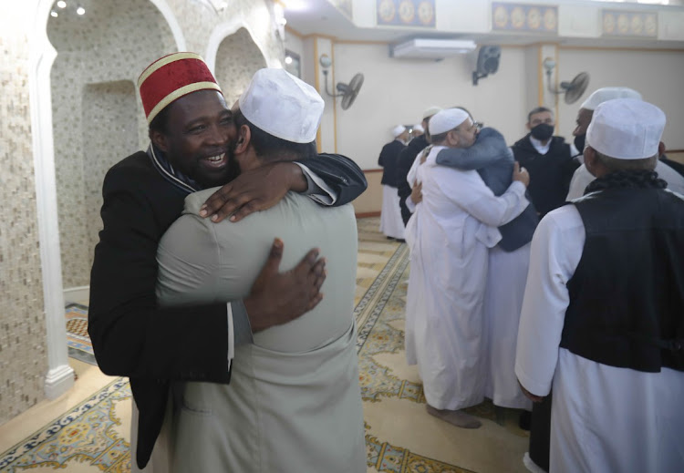 Muslims greet each other after the Eid ul Fitr prayer at the Mountview Mosque in Cape Town.