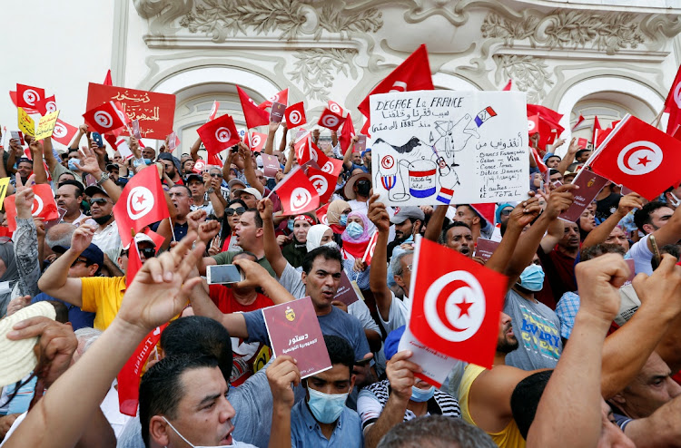 Demonstrators carry flags and banners during a protest against the Tunisian President Kais Saied's seizure of governing powers, in Tunis, Tunisia, on September 26 2021. Picture: REUTERS/ZOUBEIR SOUISSI