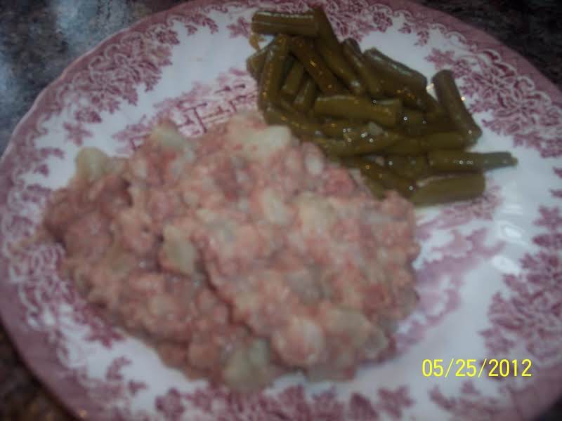 Corned Beef Hash Served With A Side Of Green Beans.