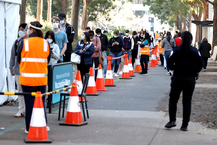 People wait in line to receive a Covid-19 shot outside a New South Wales health vaccination centre in Sydney, Australia, August 19 2021. Picture: BLOOMBERG/BRENDON THORNE