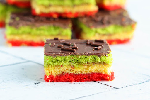 Rainbow Cookie cut into squares.