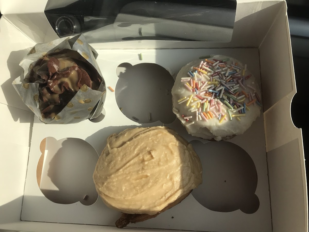 Chocolate caramel cupcake, birthday cake donut, cinnamon bun with maple frosting