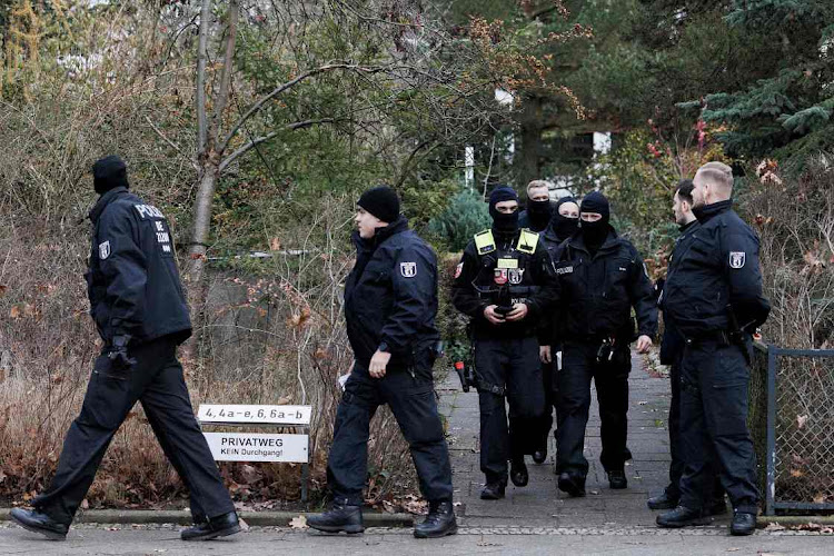 Police stand outside a residence that they raided on December 7, 2022 in Berlin, Germany. Picture: GETTY IMAGES/CARSTEN KAOLL