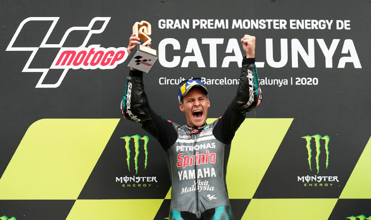 Petronas Yamaha's Fabio Quartararo celebrates with a trophy on the podium after winning the Catalunya Grand Prix in Barcelona, Spain, September 27 2020.