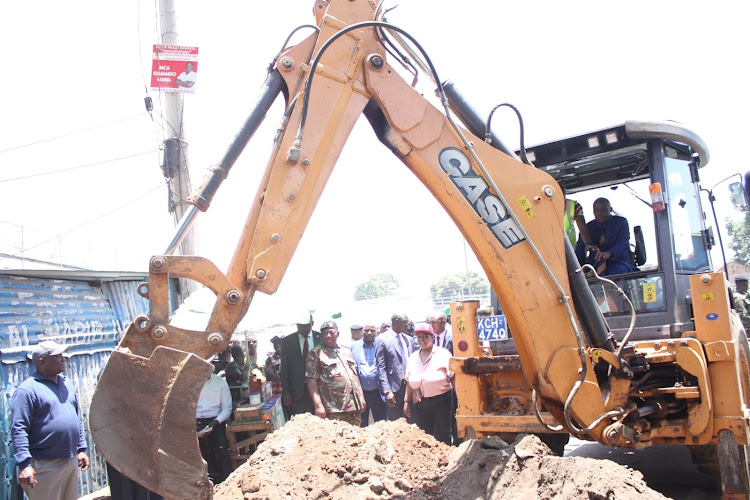 Water and Sanitation PS Paul Rono tries his hand on an excavator during a crackdown on illegal water connections at Kiamaiko in Nairobi on March 6, 2023.