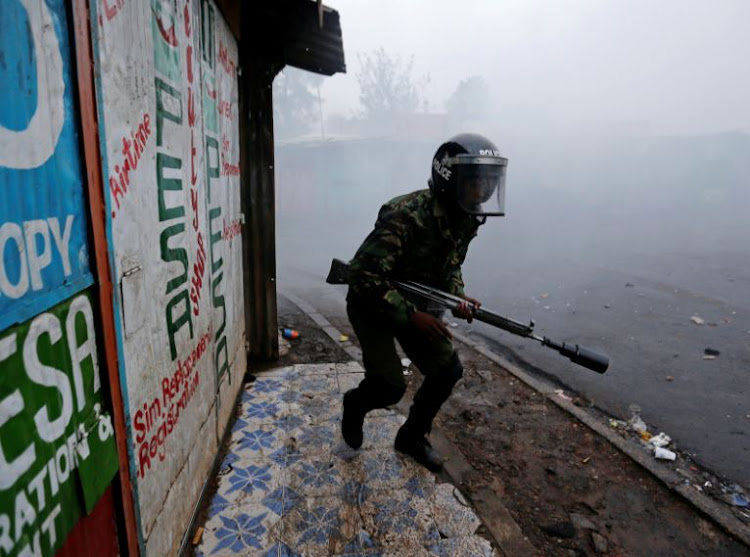 A riot policeman attempts to disperse supporters of Kenyan opposition leader Raila Odinga protesting the presidential election re-run in Kibera slums of Nairobi, Kenya October 26, 2017.