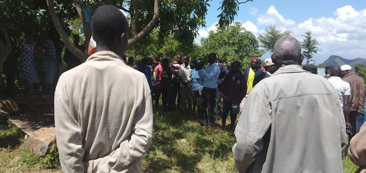 Residents of Kapkiamo in Baringo North Sub-county mill around the scene where a form three student committed suicide on Wednesday.