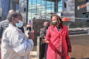 Limpopo social development MEC Nkakareng Rakgoale with the mother of the deceased children, Sylvia Monyela, outside the Limpopo high court.