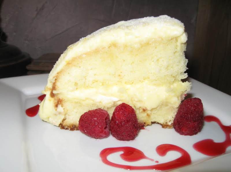 Lemoncello Creme Cake With Raspberry Chambord Syrup And Fresh Raspberries.  