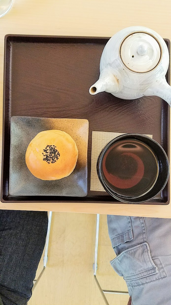 Visiting the Portland Japanese Garden Umami Cafe offering Japanese teas and snacks, Hojicha with Anpan set, a pastry with flavored red bean paste that highlights the aromatic sweetness of Hojicha tea, which is a roasted green tea