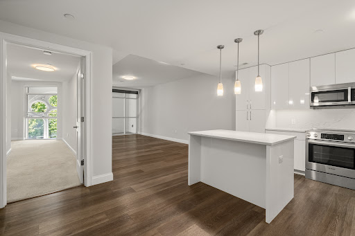 Modern kitchen with island and adjacent living room in this luxury apartment / penthouse for sale in Boston ($1,199,000)