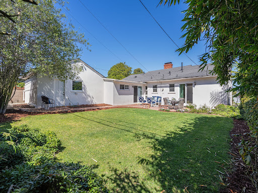 Yard with lawn and white house in this luxury property for sale in Redondo Beach ($1,899,000)