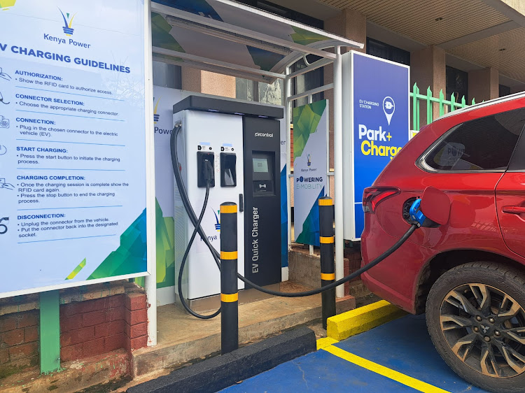 A motorist charges his electric vehicle at a free Kenya Power charging station at Stima Plaza, Parklands.