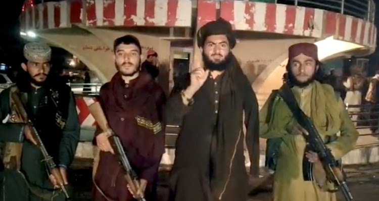 Taliban fighters record a message after seizing Pul-e- Khumri, capital of Baghlan province, Afghanistan, in this still image taken from a social media video, on August 10 2021. Picture: TALIBAN HANDOUT/REUTERS