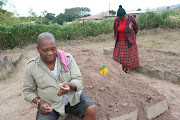 Gamelihle Dlungwane next to the grave of his wife Sindiswa on June 4, 2018. Sindiswa died on the weekend, two weeks before their scheduled wedding. He decided to marry his childhood sweetheart anyway in a traditional ceremony before her body was buried.
