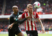 Sheffield United's Oliver McBurnie in action with Liverpool's Fabinho.