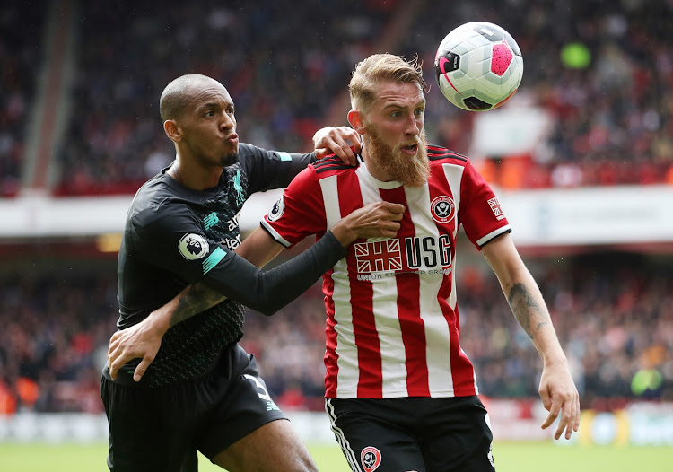 Sheffield United's Oliver McBurnie in action with Liverpool's Fabinho.