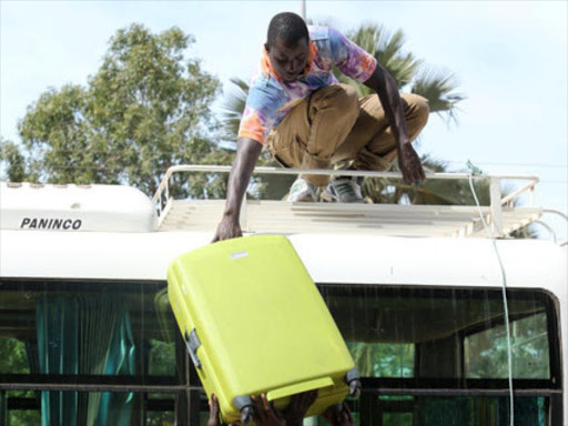 Luggage of tourists is seen loaded on a tour bus leaving for the airport a day after the country declared a state of emergency, in Banjul, Gambia January 18, 2017. /REUTERS