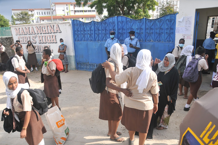 Mama Ngina students wait for their parents outside the school premises after the closure of the institution.