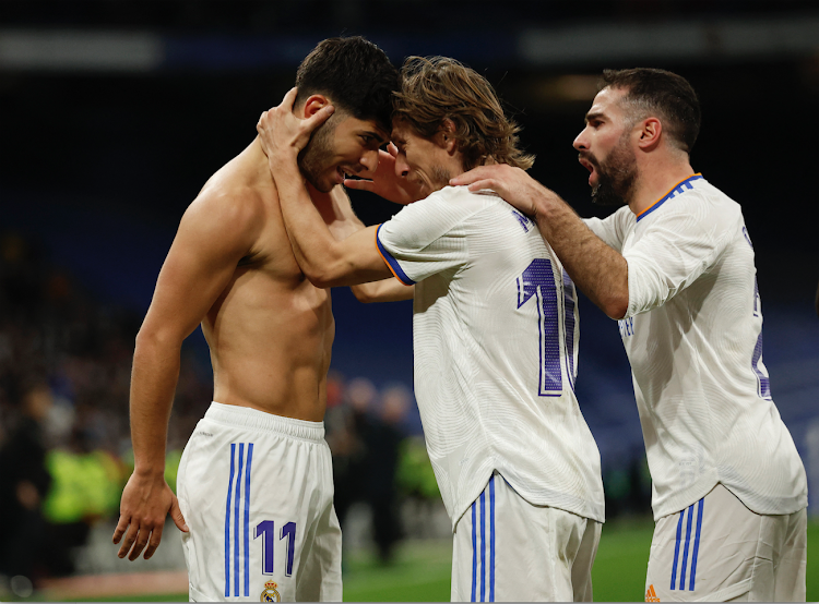 Real Madrid's Marco Asensio celebrates with Luka Modric and Dani Carvajal after scoring against Granada