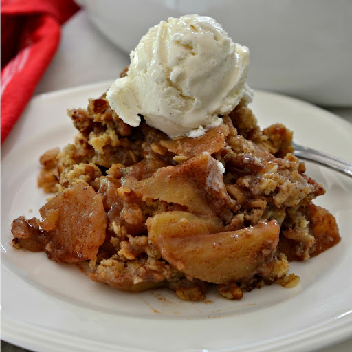 This Apple Crisp Recipe is a simple dessert made with tart apples mixed with sugar and cinnamon and topped with a crunchy sweet oatmeal pecan mixture.  The result is pure heaven and for even an more delectable treat top with a scoop of natural vanilla ice