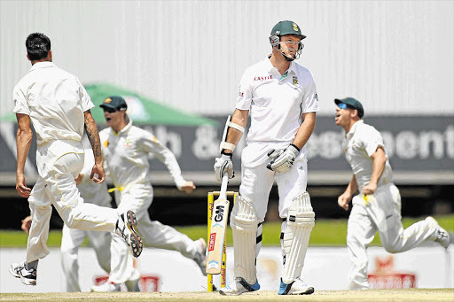 START OF THE ROT: Mitchell Johnson, left, and his teammates celebrate taking the wicket of SA skipper Graeme Smith for just four runs at Centurion yesterday