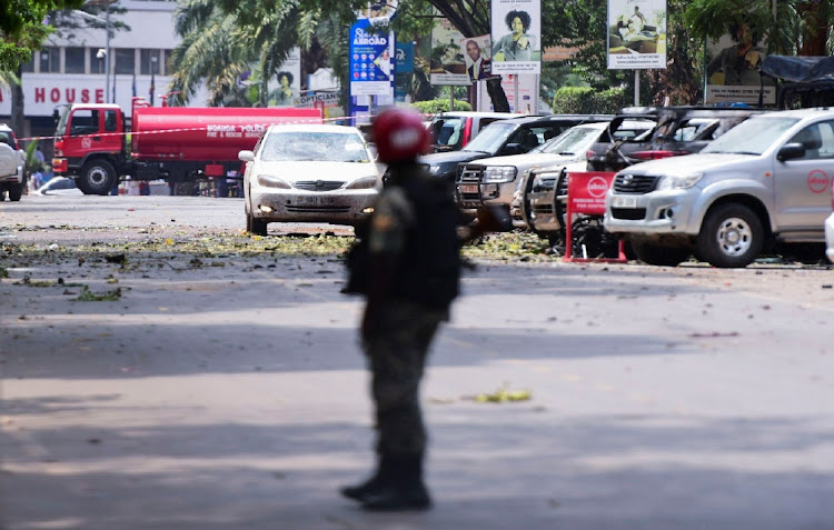 A Ugandan policeman stands guard near the scene of a blast in Kampala, Uganda, November 16 2021. Picture: ABUBAKER LUBOWA/REUTERS