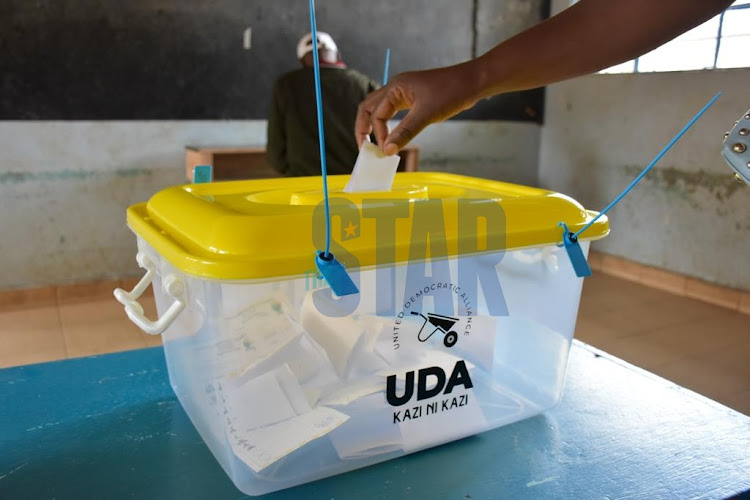 A UDA party member cast her vote at a UDA branded ballot box during the nomination process on April 14, 2022.