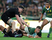 Handre Pollard of South Africa challenged by Samuel Whitelock of New Zealand during their Rugby Championship match at Mbombela Stadium.