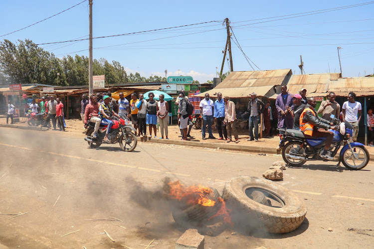 Some youths block the road to protest the alleged land grabbing in Kiberia on March 4.