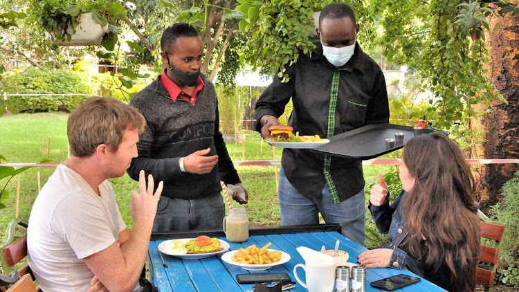 Waiters and customers communicate using sign language, gestures and mimes