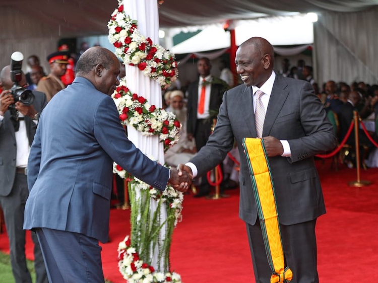 IEBC chairman Wafula Chebukati receibes his Elder of the Order of the Golden Heart (EGH) from President William Ruto during Jamhuri Day celebrations at Nyayo Stadium on Monday, December 12.