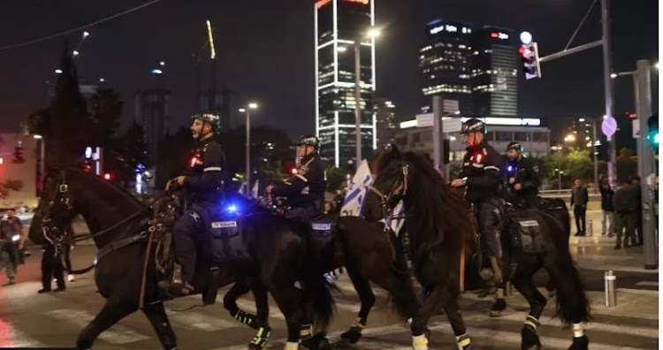 Riot police on horseback clash with anti-government demonstrators in Tel Aviv